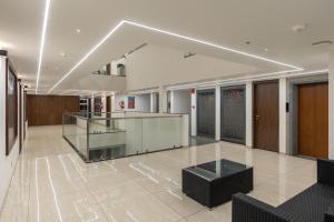 an empty lobby with a reception desk in a building at The Living Hub Business Hotel, Kolhapur in Kolhapur