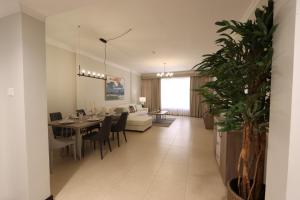 a living room and dining room with a dining table at Aman Plaza in Juffair