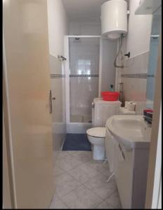 a bathroom with a toilet and a sink and a shower at Apartment Mystic in Split