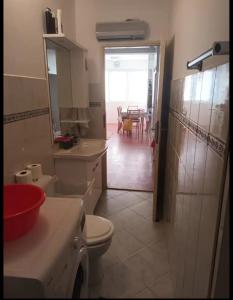 a bathroom with a toilet and a sink and a table at Apartment Mystic in Split