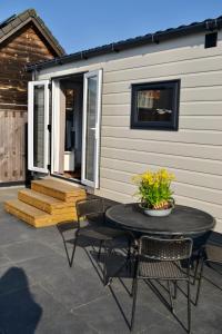 a patio with a table and chairs and a building at Chalet 27 in Zandvoort