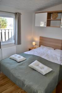 a bedroom with a bed with two towels on it at Chalet 27 in Zandvoort