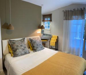 a bedroom with a bed and a desk in it at La Vagabonde in Saint-Tropez +19 photos