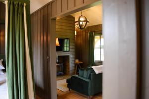 a living room with a green couch and a chair at Retreat East in Ipswich