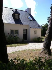 a white house with a black roof at Maison de 2 chambres avec jardin clos et wifi a Ploemel in Ploemel