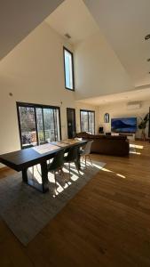 a large living room with a table and a couch at Villa contemporaine, jardin méditerranéen et piscine privée in Saint-Jean-Pla-de-Corts