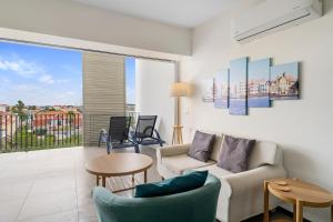 a living room with a couch and a table at The Ritz Village in Willemstad