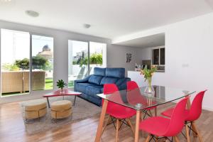 a living room with a blue couch and red chairs at Atico Altea17 by Vero in Altea