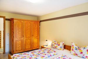 1 dormitorio con 2 camas y armario de madera en An den Weinbergen en Bingen am Rhein