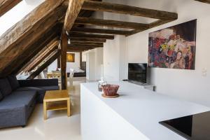 a living room with white walls and wooden beams at Central Living Apartments - Berggasse in Vienna