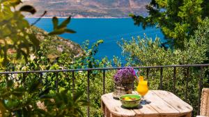a wooden table with a vase and flowers on a balcony at Fidanka Hotel in Kalkan