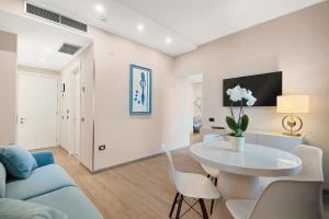 a living room with a table and a couch at Hotel Excelsior in Marina di Massa