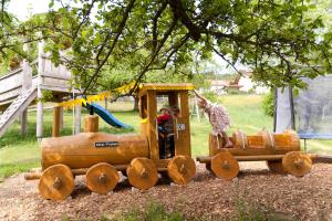 a wooden toy train with a giraffe on it at Landgasthof Postwirt in Lam