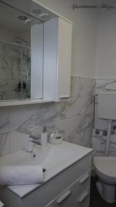a white bathroom with a sink and a toilet at Apartments Marja in Njivice +27 photos