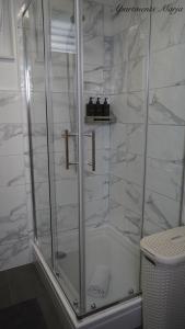 a shower with a glass door in a bathroom at Apartments Marja in Njivice