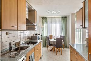 a kitchen with a sink and a table with chairs at Haus Zum Rochusberg 1 in Bingen am Rhein