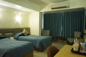Postel nebo postele na pokoji v ubytování Hotel Diplomat, Colaba