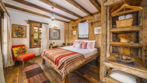 a bedroom with a bed and a chair in a room at Fidanka Hotel in Kalkan