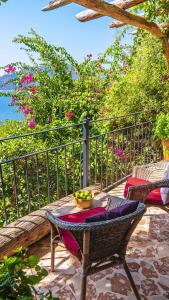a table and chairs on a patio with a fence at Fidanka Hotel in Kalkan