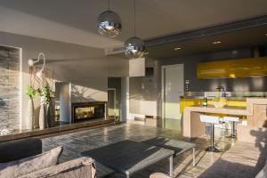 uma cozinha e sala de estar com uma mesa e uma lareira em Luxury Beachfront Villa Selenia Gold in Sounio em Sounio