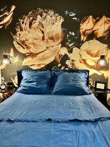 a bedroom with a bed with a flower mural on the wall at Silesia Apartments B129 in Ustroń
