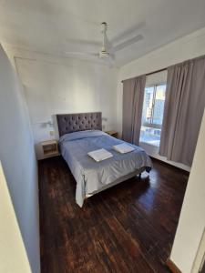 a bedroom with a bed and a large window at Loft con todo que necesitas solo a 2 cuadras de la costanera!! in Corrientes