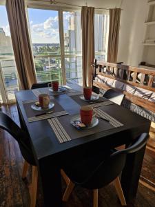 a dining room table with two cups of coffee on it at Loft con todo que necesitas solo a 2 cuadras de la costanera!! in Corrientes