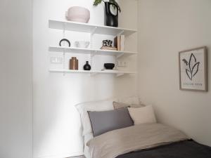 a white room with a couch and shelves at Waterfront Cabins in Gothenburg