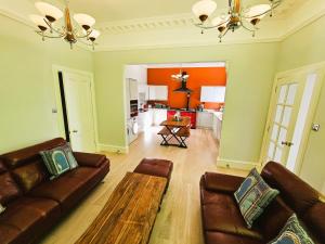 a living room with a couch and a table at Merchant's View - Luxury Seaside Designer Retreat in Rothesay