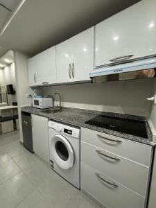 a kitchen with a washing machine and a sink at Scandic Resort, free WiFi, sandy beach, coral reef in Hurghada