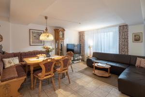 a living room with a couch and a table at Rosenhof am See in Thiersee