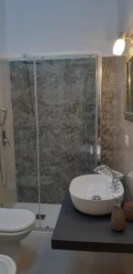 a bathroom with a sink and a shower at Casa Ethno Stintino-Private pool in Stintino
