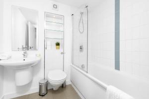 a white bathroom with a toilet and a sink at City Centre Apartment - 2 Bedrooms - Secure Parking - Excellent Location - 99Q in Birmingham