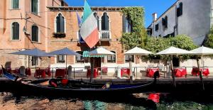 a gondola sitting in the water in front of a building at Messner Palace in Venice