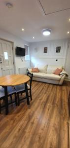 a living room with a couch and a table at Self-contained Guest Suite in Guildford