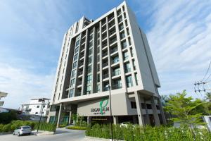 a large white building with a sign on it at Sugar Palm Residence in Phuket Town