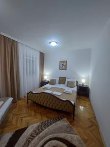 a bedroom with a bed with a couch in it at Jana apartments 2 in Tivat
