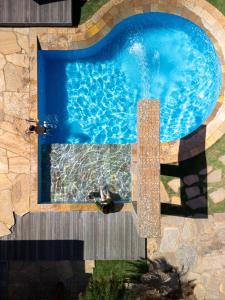 a man in a swimming pool with a person in the water at Ucayali Hotel in Sinop