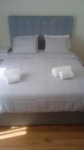 a large white bed with two towels on it at Lisbon Breezy Haven 2Bedroom Oasis in Lisbon