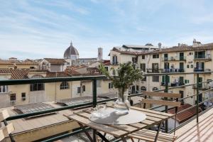a table on a balcony with a view of the city at Sunrise View Apartment in Florence