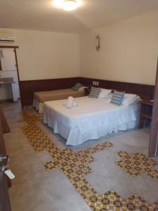 a room with two beds in a room with at Pousada Vila do Beco in Arraial d'Ajuda