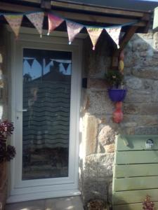 a front door of a house with a flag over it at Little Pedn in Penzance