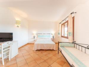 a large room with two beds and a tv at Apartment in Vignola Mare near Sandy Beach in Vignola Mare