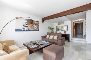 a living room with a couch and a table at Casa Jardines del Sol J5 in Marbella
