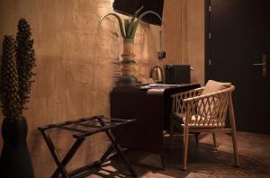 a desk with a chair and a table with a plant at Hostel 7 in Florence