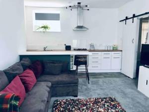 a living room with a couch and a kitchen at Galashiels, Scottish Borders, One Double Bed in Galashiels