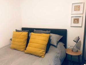 a bed with two yellow pillows on it at Galashiels, Scottish Borders, One Double Bed in Galashiels