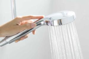 a person is holding a shower handle at Galashiels, Scottish Borders, One Double Bed in Galashiels +5 photos