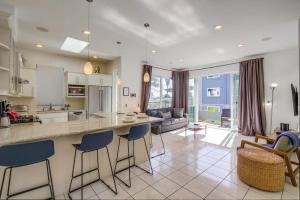 a kitchen and living room with a counter and chairs at Bay Shores in San Diego