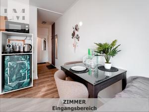 a living room with a table and chairs in a room at LM-ApartmentsMainz-07 in Mainz
